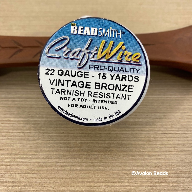 May include: A spool of 22 gauge, 15 yard vintage bronze CraftWire, tarnish resistant, made in the USA.  The spool is labeled "The Beadsmith Pro-Quality CraftWire".