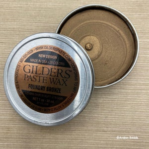 May include: A small tin of Gilders Paste Wax in Foundry Bronze. The label reads "New Design, Made in USA, 28 Colors, Covers over 30 sq/ft - 2.78 sq/m, Net 1 oz - 30 ml by Volume".
