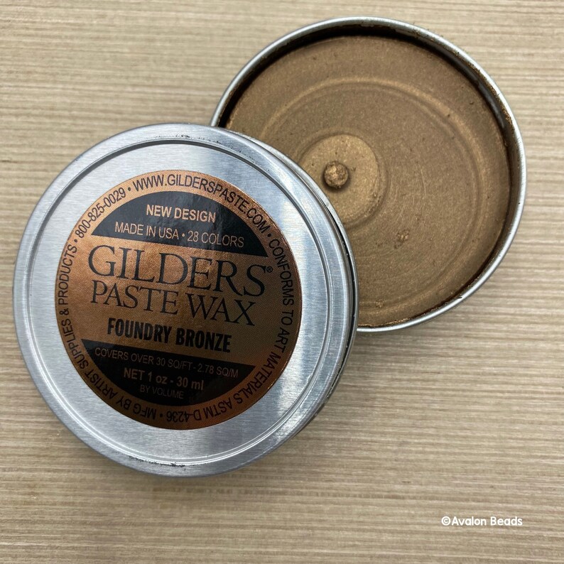 May include: A small tin of Gilders Paste Wax in Foundry Bronze. The label reads "New Design, Made in USA, 28 Colors, Covers over 30 sq/ft - 2.78 sq/m, Net 1 oz - 30 ml by Volume".