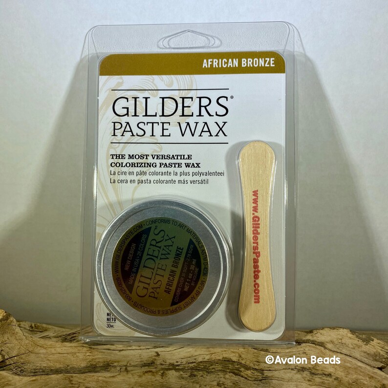 Pode incluir: Uma pequena lata de Cera em Pasta Gilders na cor Bronze Africano. A lata &eacute; de prata com um r&oacute;tulo preto e texto branco. O r&oacute;tulo inclui o nome da marca, o nome do produto, a cor e o peso l&iacute;quido. A lata &eacute; embalada com um aplicador de madeira. A embalagem &eacute; de pl&aacute;stico transparente com um fundo dourado e o nome da marca e o nome do produto em texto preto.
