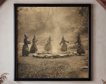 May include: A sepia-toned framed print depicts witches dancing around a fire. The image hangs above a dark gray sofa with throw pillows. The room features exposed wooden beams, a brick wall, and a patterned rug, creating a cozy, rustic atmosphere.