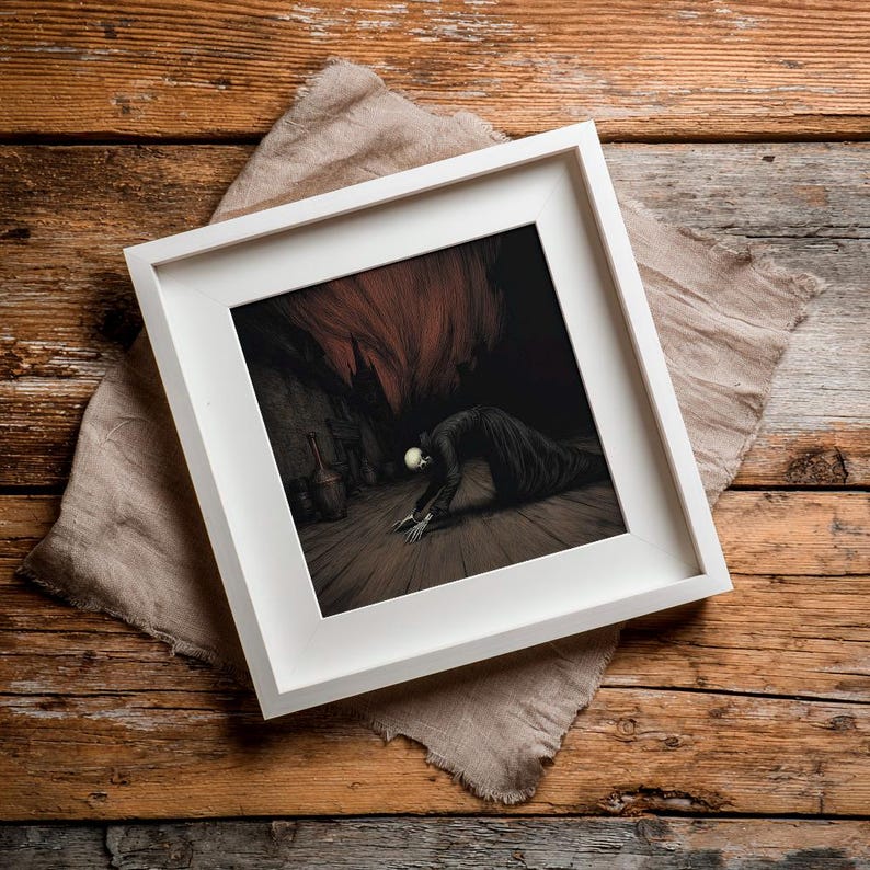 May include: A framed artwork with a white border. The artwork depicts a dark, surreal scene of a figure with a skull-like head and skeletal hands, kneeling on a wooden floor. The background features a cavernous space with a red, ominous glow.