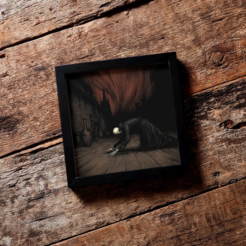 May include: A framed artwork depicting a skeletal figure in a dark robe kneeling on a wooden floor. The background features a shadowy interior with a fiery, red-orange element above. The frame is black.