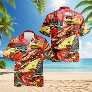 May include: Short-sleeved button-down shirt with a vibrant, colorful design. The shirt features a collage of vintage race cars, cartoonish illustrations of a cobra and a devil, and portraits of two men. The background is a tropical beach scene.