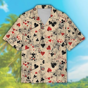 May include: Short-sleeved button-down shirt with a beige background and a playing card pattern. The cards feature red hearts, black clubs, spades, and diamonds. The shirt has a classic collar and a relaxed fit.