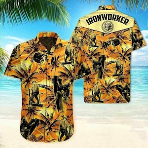 May include: Orange and yellow Hawaiian shirt with a tropical beach scene and palm trees. The shirt features a repeating pattern of ironworkers and the word "IRONWORKER" across the back.