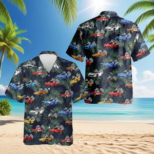 May include: Short-sleeved button-down shirt featuring a vibrant print of colorful race cars and checkered flags on a dark blue background. The shirt has a classic collar and is set against a tropical beach scene with palm trees and a sunny sky.