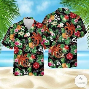 Könnte beinhalten: Schwarzes Hawaiihemd mit Drachen-, Würfel- und Blumenmuster. Das Hemd zeigt einen Drachen, der eine geometrische Form hält, rote Würfel, Ananas und tropische Blumen. Es hat kurze Ärmel und einen Knopfkragen.
