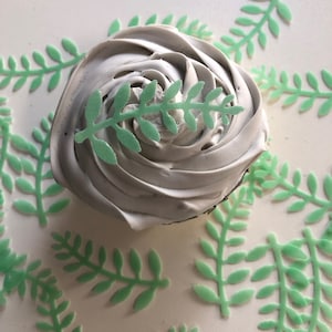 24 little edible green leaves ferns cupcake toppers about 1.75" long.  Wafer paper cake decorations. Edible ferns for dinosaur cakes