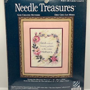 May include: A cross-stitch kit by Needle Treasures, featuring a framed design with the text "God could not be everywhere so He created Mothers." The design includes a floral wreath with pink roses and a pink background. Finished size is 8" x 10".