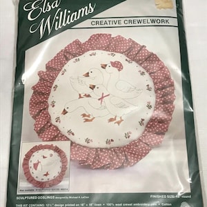 May include: Elsa Williams Creative Crewelwork kit featuring a round design with geese. The kit includes a 12.5" design printed on 18" x 18" linen, embroidery yarn, cotton floss, ribbon, batting, lining, calico, needles, and instructions.