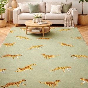 May include: A rectangular area rug in a light green hue, adorned with multiple cheetah illustrations in shades of brown and yellow. The rug is placed in a living room setting, with a sofa and coffee table.