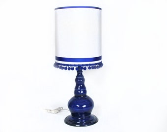 Cobalt blue ceramic lamp with pompom shade