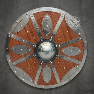 May include: A circular wooden shield featuring a central polished steel boss, a reinforced steel rim, and eight radiating steel spokes. The wood grain is visible between the metal accents, which are secured with numerous small steel rivets.