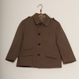 May include: A brown blazer with a button-up front and two pockets. The blazer has a label that says "L'ACTUEL" on the hanger.