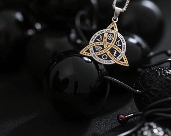 May include: A silver necklace with a gold and silver pendant. The pendant is a triangle shape with the words "Speak with Love", "Be Kind", and "Listen with Love" engraved on it. The pendant also has symbols and the words "Honor Your Word", "Be Balanced", and "Mind Boundaries".