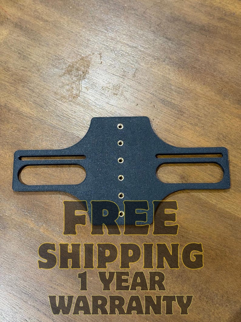 May include: A black metal bracket with a series of small holes and two elongated openings. The bracket has the text "FREE SHIPPING 1 YEAR WARRANTY" in a gold color.