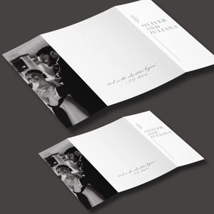 May include: Two white wedding invitation cards, folded in a trifold style, with a black and white photo of a couple dancing. The text "OLIVER AND JULIANA" is printed at the top, with the quote "And on the adventure begins." below.