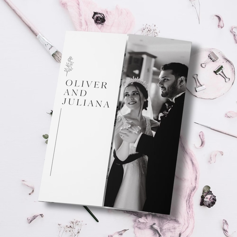 May include: A wedding invitation featuring a black and white photograph of a couple dancing. The left side of the invitation has the names "OLIVER AND JULIANA" in a serif font, with a floral design. The invitation is surrounded by pink floral decorations.