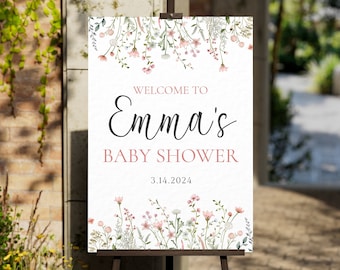 May include: A white welcome sign with a floral border and the text "Welcome to Emma's Baby Shower 3.14.2024".