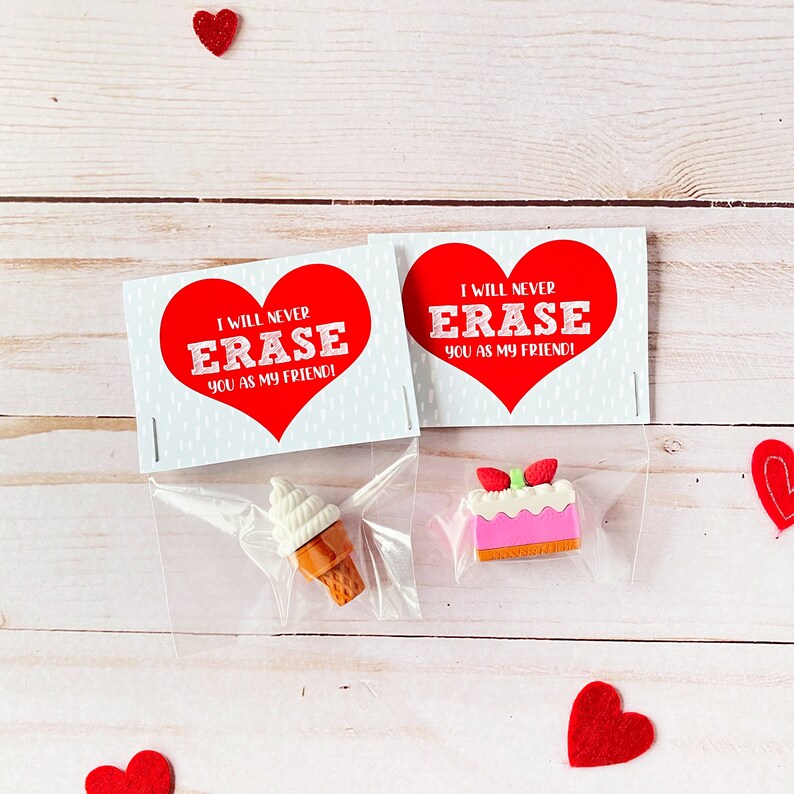 May include: Two Valentine's Day gift bags with red heart-shaped erasers and a message that reads "I will never erase you as my friend!" One bag contains a pink and white cake eraser and the other contains a white and brown ice cream cone eraser.