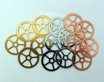 May include: A collection of gold, silver, and copper gears. The gears are arranged in a circular pattern, with the gold gears in the center and the silver and copper gears surrounding them.