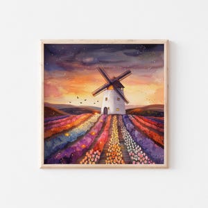 Könnte beinhalten: Aquarellmalerei eines weißen Windmühle mit schwarzen Flügeln vor einem Sonnenuntergangshimmel. Bunte Blumenreihen in Lila, Orange und Gelb führen zur Windmühle. Das Kunstwerk ist in einem hellen Holzrahmen gerahmt.