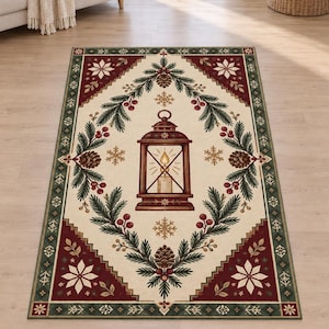 May include: A rectangular area rug featuring a cream-colored center with a central illustration of a lit lantern surrounded by pine branches, pinecones, and red berries. The border is deep red with white snowflake patterns and green accents.
