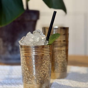 May include: A set of three ceramic mugs with a speckled, matte finish in cream, light grey, and dark grey. Each mug has a simple, minimalist design and a rounded handle.