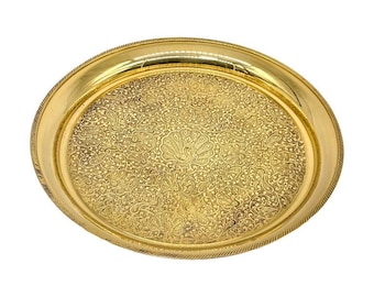 May include: A gold-colored, oval serving tray with an intricate floral and paisley pattern. The tray has a raised edge with a rope-like design. The center of the tray features a peacock-like design.