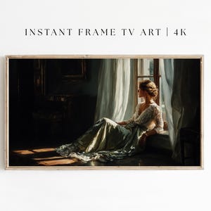 May include: A framed digital art print for TV screens. The artwork depicts a woman in a flowing gown seated by a window, bathed in sunlight. The image has a vintage aesthetic, with soft colors and a focus on light and shadow. The text "INSTANT FRAME TV ART | 4K" is at the top.