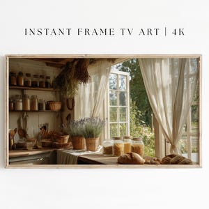 以下が含まれることがあります： テレビ画面用の額入りデジタルアート作品で、素朴なキッチンのシーンが特徴です。画像には、シアーなカーテンのある窓、穀物の瓶、パンのパンが表示されています。「INSTANT FRAME TV ART | 4K」というテキストが上部にあります。