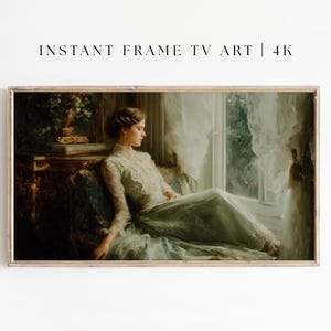 May include: A framed digital print of a classical painting. The artwork depicts a woman in a long, light green dress seated near a window. The text "INSTANT FRAME TV ART | 4K" is at the top of the frame.
