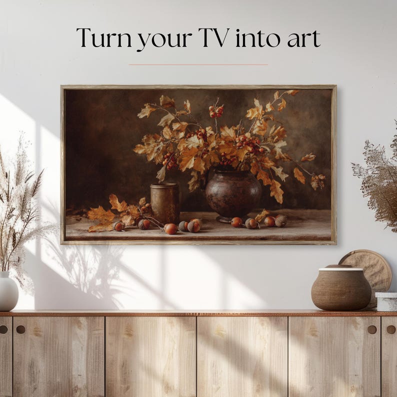 Pu&ograve; includere: Un'opera d'arte incorniciata con una natura morta con un vaso di foglie e bacche autunnali. L'opera d'arte &egrave; in una cornice di legno ed &egrave; esposta sopra un mobile di legno. Il testo "Turn your TV into art" &egrave; nella parte superiore dell'immagine.