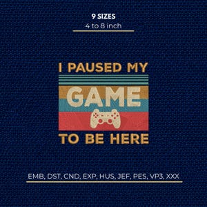 May include: An embroidery design featuring the text I PAUSED MY GAME TO BE HERE in gold, with a central game controller icon. The design includes horizontal stripes in teal, tan, and red, with 9 sizes from 10.16 to 20.32 cm and file formats listed.
