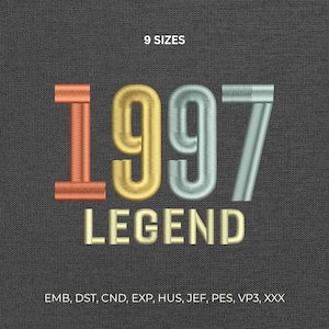 May include: Embroidered design on a dark gray fabric. The design features the year "1997" in orange, gold, and silver, with "LEGEND" below in gold. The text "9 SIZES" is at the top.