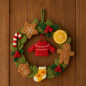 May include: A handmade Christmas wreath with a green base, adorned with crocheted ornaments. Includes a red sweater, gingerbread man, star, candy cane, orange slice, house, and stocking. The wreath is decorated with red berries.