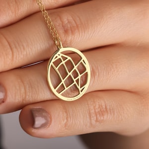 May include: A gold-colored pendant necklace featuring a circular, openwork design with a map-like pattern. The pendant is suspended from a delicate chain. The text "I love you More Everyday" is engraved on the pendant.