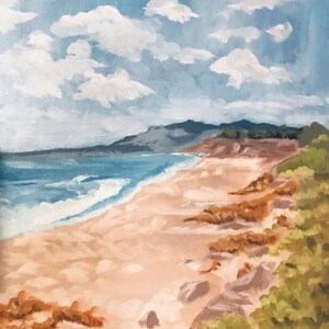 May include: A painting of a beach scene with a sandy shore, blue ocean waves, and a green hillside in the background. The sky is a light blue with white clouds.
