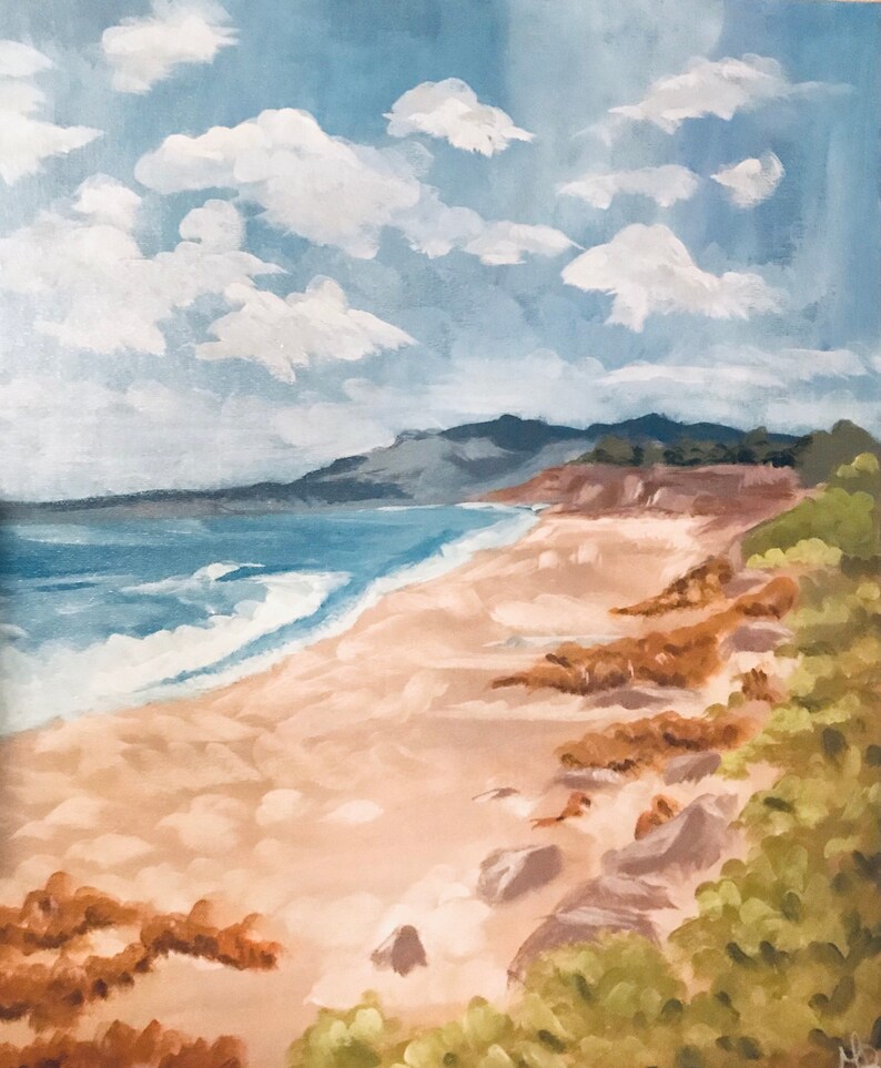 May include: A painting of a beach scene with a sandy shore, blue ocean waves, and a green hillside in the background. The sky is a light blue with white clouds.