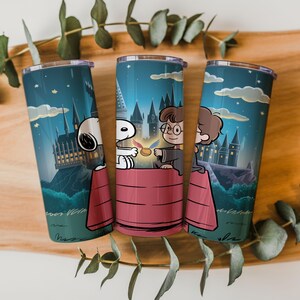May include: Three stainless steel tumblers with a cartoon illustration. The design features Snoopy, Harry Potter, and another character in front of Hogwarts Castle. The tumblers have a dark blue background with stars and clouds.