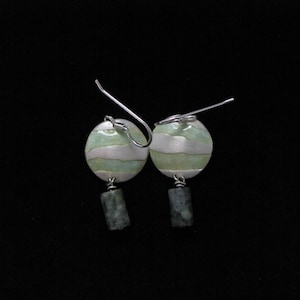 Round, silver, domed drop earrings with pale green faux enameling and dark green, barrel bead