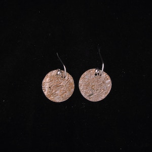 Silver, round dangle earrings with distressed texture and copper colored wash