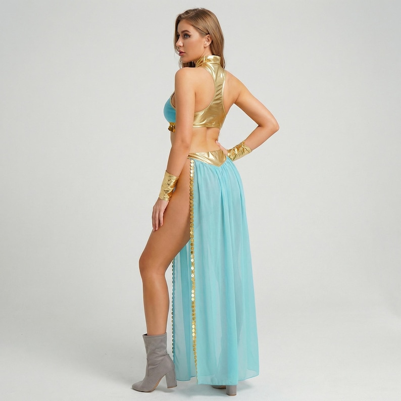 May include: A gold and blue costume with a high collar and a flowing skirt. The top is gold, with a blue bra underneath. The skirt is light blue with gold trim and a high slit. Gold arm cuffs and gray boots complete the look.