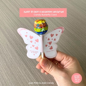 May include: A candy butterfly card for Valentine's Day. The card is white with pink accents and heart details. The card has the text "You are sweet as candy!" and "From your friend". A lollipop is attached to the card. The text "SWEET & EASY CLASSROOM VALENTINE Candy Butterfly Card" is at the top.