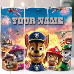 May include: A personalized tumbler featuring the Paw Patrol characters with the text "YOUR NAME" in large letters. The design includes images of Chase, Marshall, Skye, and other pups, with a background of fireworks and rescue vehicles.