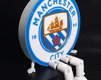 Placa 3D del Manchester City con pernas articuladas