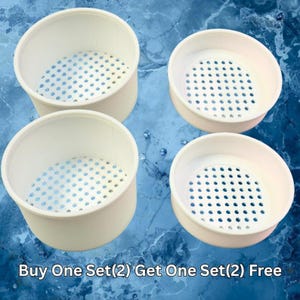 May include: Four white, round containers with perforated bases are displayed on a blue, textured surface. The containers have a cylindrical shape with a slightly flared rim. The text "Buy One Set(2) Get One Set(2) Free" is at the bottom.
