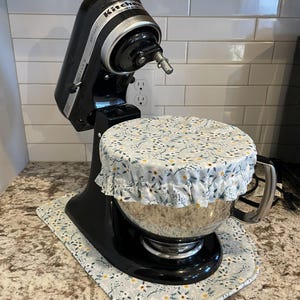 May include: A set of three ceramic mugs with a speckled, matte finish. The mugs are in shades of cream, light gray, and dark gray. Each mug has a simple, minimalist design, perfect for coffee or tea.