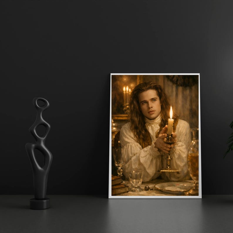 May include: A framed print featuring a portrait of a person holding a lit candle. The person is wearing a white ruffled shirt. A black abstract sculpture is on the left. The background is dark with a table setting.